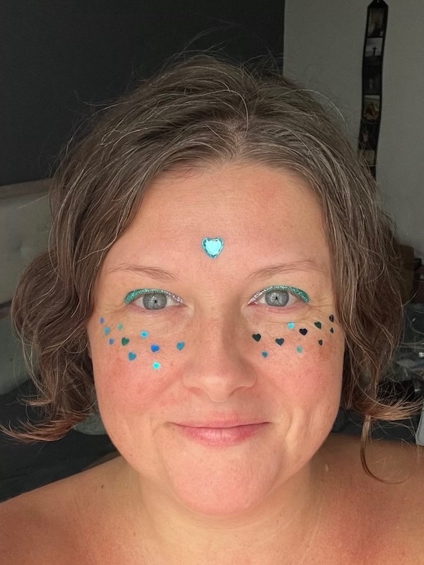Teal heart and gems festival face art