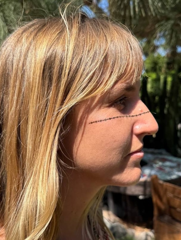 Minimal dotted line face art outdoors